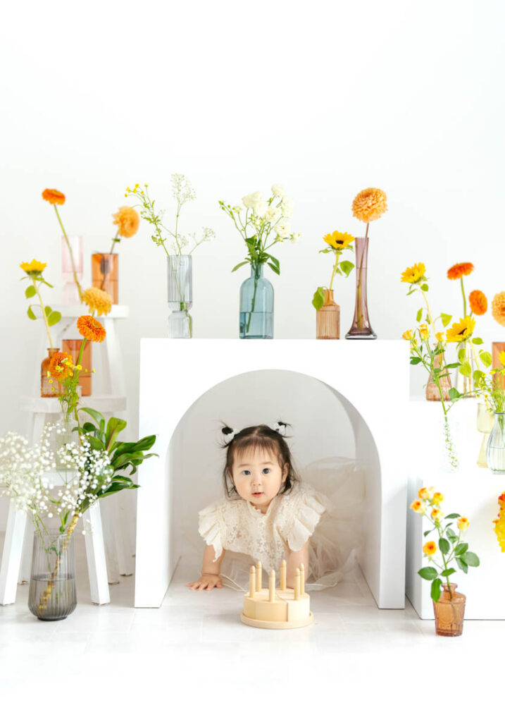 花とアーチに囲まれて遊ぶかわいい子どもの微笑ましい瞬間